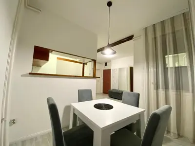 a dining room with a white table and chairs at Grand Royal in Belgrade