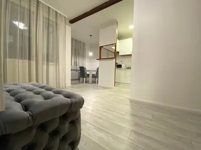 a living room with a couch and a kitchen at Grand Royal in Belgrade