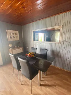 a dining room table with chairs and a bowl of fruit on it at Smokvica in Stari Slankamen