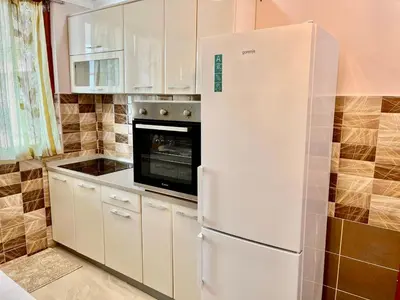 a kitchen with a white refrigerator and a microwave at Belgrade heart of a historical center in Belgrade