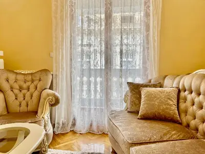 a living room with a couch and a window at Belgrade heart of a historical center in Belgrade