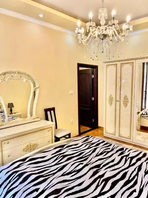 a zebra print bedroom with a bed and a chandelier at Belgrade heart of a historical center in Belgrade