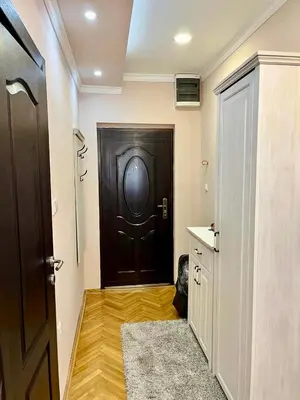 a hallway with a black door and a wooden floor at Belgrade heart of a historical center in Belgrade
