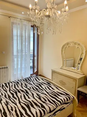 a zebra print bed in a bedroom with a mirror at Belgrade heart of a historical center in Belgrade