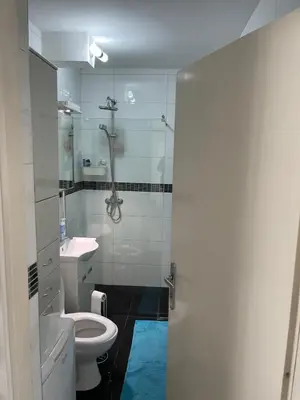 a bathroom with a toilet and a glass shower at Milan in Belgrade