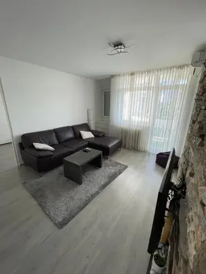 a living room with a black couch and a table at Milan in Belgrade
