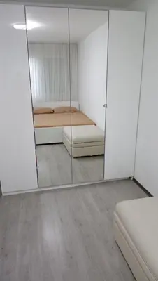 a mirrored room with a bed and a mirror at Milan in Belgrade