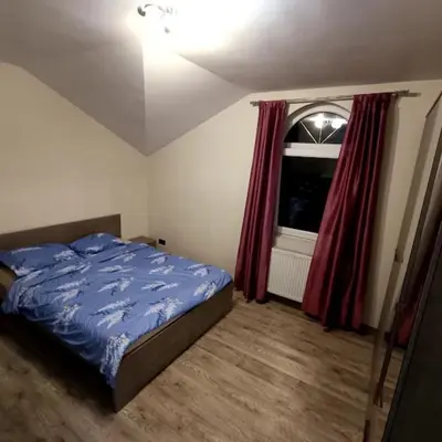 a bedroom with a blue bed and a window at MARIJA sa besplatnim parkingom in Novi Beograd