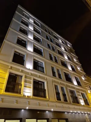 a tall white building with windows at night at H41 Luxury Suites in Belgrade