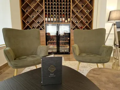 a tasting room with two chairs and a wine cellar at H41 Luxury Suites in Belgrade