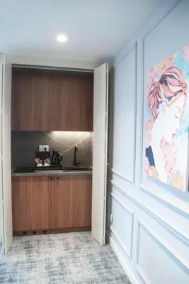 a kitchen with a painting of a woman on the wall at H41 Luxury Suites in Belgrade