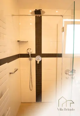 a shower with a phone in a bathroom at Belrado Apartments in Belgrade