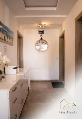 a kitchen with a clock on the wall at Belrado Apartments in Belgrade
