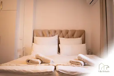 a bedroom with a bed with two towels on it at Belrado Apartments in Belgrade