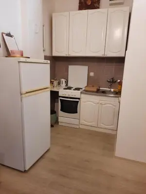 a kitchen with white cabinets and a white refrigerator at Flat in Belgrade city center, 45m2 in Belgrade