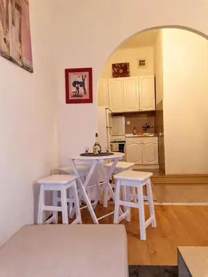 a kitchen with white tables and stools in a room at Flat in Belgrade city center, 45m2 in Belgrade