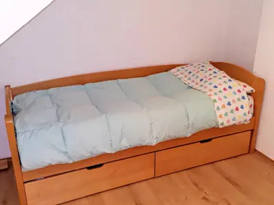 a bed with a wooden frame in a room at Flat in Belgrade city center, 45m2 in Belgrade