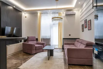 a living room with a couch and a tv at Knez Imperium in Belgrade