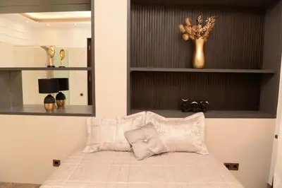a bedroom with a bed and a vase with flowers at Knez Imperium in Belgrade