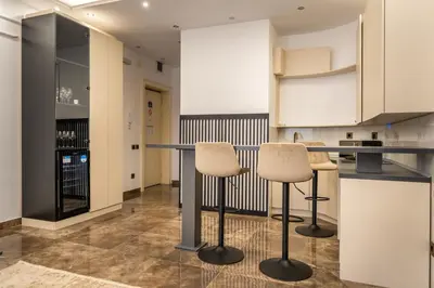 a kitchen with a counter and two stools at Knez Imperium in Belgrade
