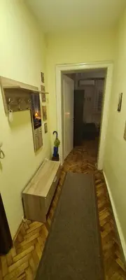 a room with a wooden bed in the middle of a room at Apartman Valdano in Belgrade