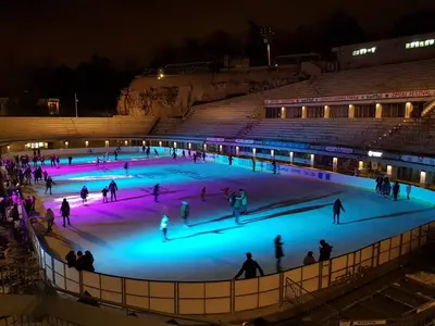a group of people on an ice rink at night at Apartman Valdano in Belgrade