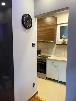 a clock on a wall in a kitchen at Apartment Vračar in Belgrade
