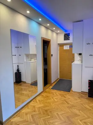 a room with a mirror and a hallway with a door at Apartment Vračar in Belgrade