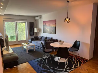 a living room with a couch and a table at Apartment Vračar in Belgrade