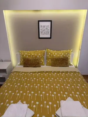 a bedroom with a bed with a sign on the wall at Apartment Arena Lux in Fontana