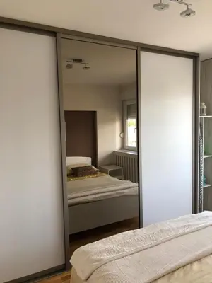 a bedroom with a mirror and a bed in it at Apartment Arena Lux in Fontana