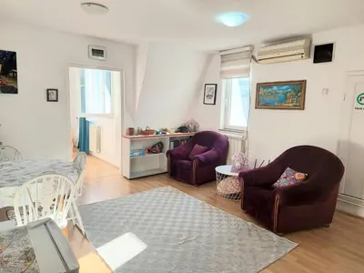a living room with two chairs and a table at Apartment in the downtown - walking distance all attractions in Belgrade