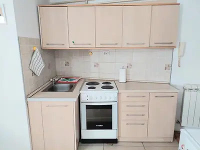 a small kitchen with a stove and a sink at Apartment in the downtown - walking distance all attractions in Belgrade