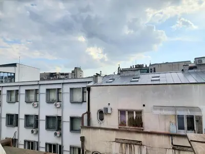 a white building with windows on top of it at Apartment in the downtown - walking distance all attractions in Belgrade
