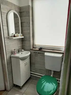 a bathroom with a sink and a toilet and a mirror at Apartment in the downtown - walking distance all attractions in Belgrade