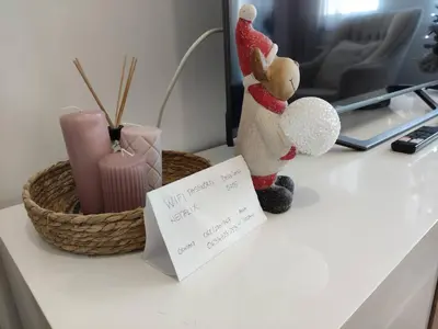 a table with a stuffed animal and a basket on it at BellaCasa AirportStudio in Surčin