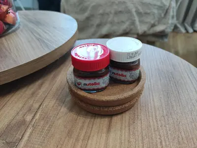 two jars of jam sitting on top of a wooden table at BellaCasa AirportStudio in Surčin