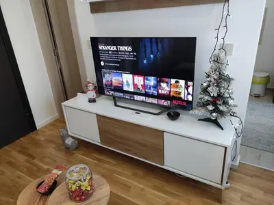 a living room with a television and a christmas tree at BellaCasa AirportStudio in Surčin