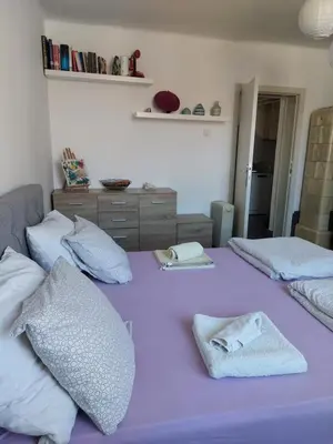 two beds in a room with purple sheets and pillows at Charming and stylish centrally located 50m2 in Belgrade