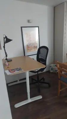 a desk with a chair and a desk with a lamp at Charming and stylish centrally located 50m2 in Belgrade