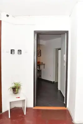 a hallway with a door to a room with a table at Charming and stylish centrally located 50m2 in Belgrade