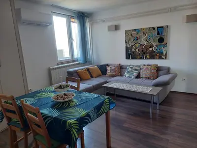 a living room with a couch and a table at Charming and stylish centrally located 50m2 in Belgrade