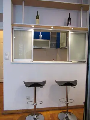 a kitchen with two stools at a counter at Apartment Grmech in Novi Beograd