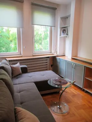 a living room with a couch and two windows at Apartment Grmech in Novi Beograd