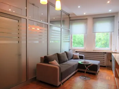 a living room with a couch and some windows at Apartment Grmech in Novi Beograd