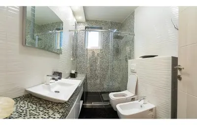 a bathroom with a sink and a toilet at Dani City Center Apartment in Belgrade