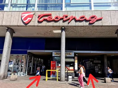a store front of a store with red arrows in front at Dani City Center Apartment in Belgrade