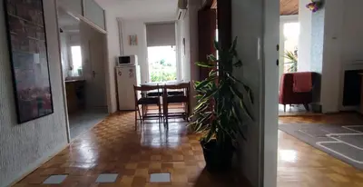 a kitchen and dining room with a table and chairs at Sokolov Apartment in Smederevo