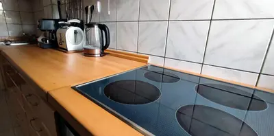 a kitchen counter with a blue stove top oven at Sokolov Apartment in Smederevo