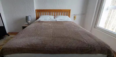 a large bed in a bedroom with a large bedspread at Sokolov Apartment in Smederevo